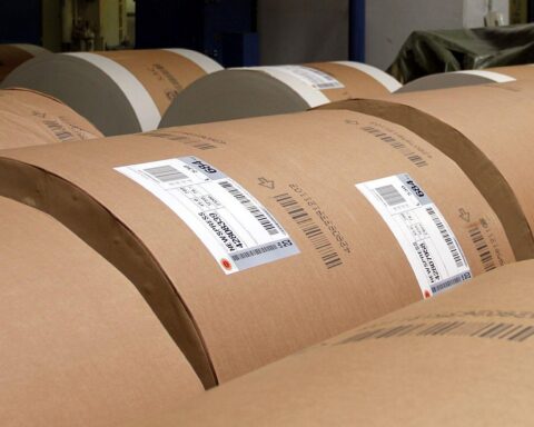 Papierrollen symbolisieren die Zusammenführung regionaler Zeitungen zur Stärkung der bayerischen Medienlandschaft.