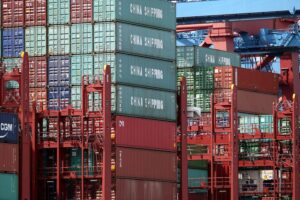 Container im Hafen, symbolisieren den internationalen Handel und Debatten über Unternehmensverantwortung.