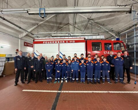 Junge Feuerwehrmitglieder feiern Erfolge, Beteiligung an Versammlung mit Wahlen und Aktivitäten.