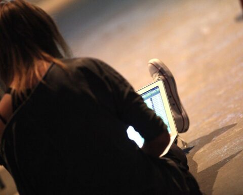 Eine Computer-Nutzerin, die Facebook verwendet, symbolisiert digitale Medien und Plattformen.