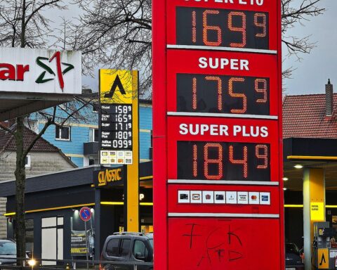 Tankstellen mit Preisanzeigen für Super E10 und Diesel, steigende Kraftstoffpreise im Hintergrund.