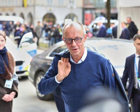 Friedrich Merz spricht auf CDU-Bundesparteitag, umgeben von Delegierten und Ausstellern in Stuttgart.