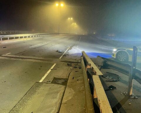 Unfallstelle mit beschädigter Schutzplanke, schwarzem BMW X5 und Polizeiabsperrung.