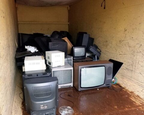 Kaputte Fernseher in einem Container symbolisieren Elektroaltgeräte-Recycling und Umweltbewusstsein in Deutschland.