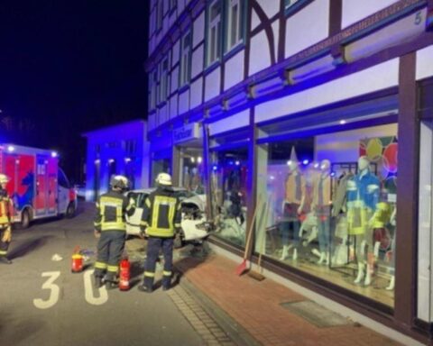 Schwerer Verkehrsunfall: Auto prallt in Geschäft, zwei Personen lebensgefährlich verletzt. Polizei ermittelt.