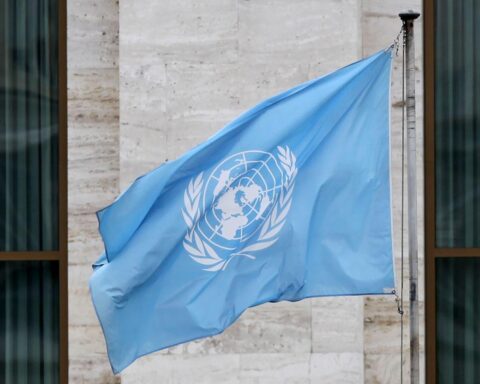 Fahne der Vereinten Nationen vor Hintergrund, symbolisiert internationale Verantwortung und Gerechtigkeit im Sudan.