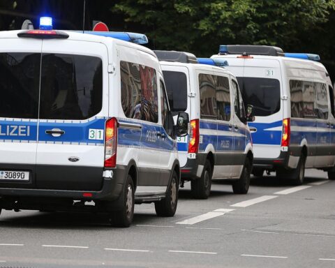 Polizeiautos vor einem Revier symbolisieren Sicherheitsstatistiken und Kriminalitätsrückgang in Berlin.
