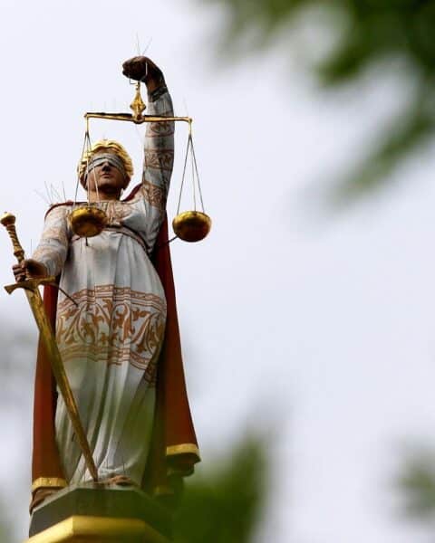 Justicia-Symbol, das Gerechtigkeit und die Schwere des Mordfalls mit einem traurigen Kontext kombiniert.