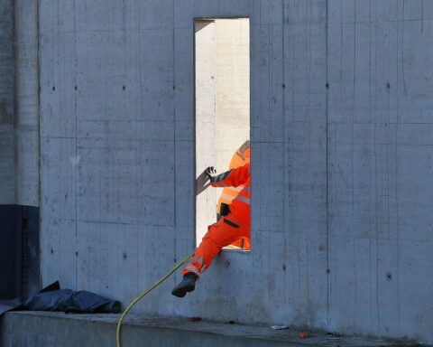 Bauarbeiter auf Baustelle diskutieren über steigende Baupreise in Thüringen.