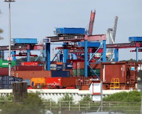 Container im Hafen, Symbol für Wirtschaftswachstum und aktuelle Herausforderungen durch den Iran-Krieg.