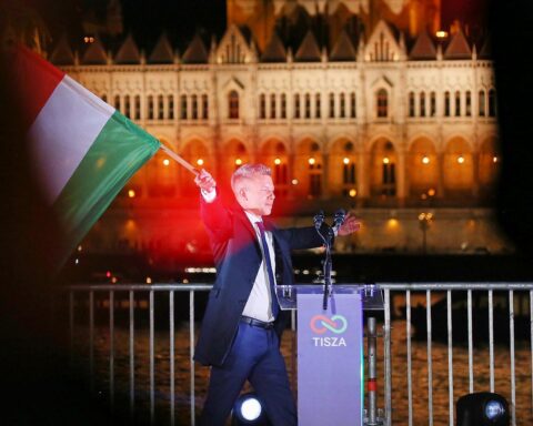 Péter Magyar feiert den Wahlsieg mit Unterstützern in jubilierender Atmosphäre vor Parteimitgliedern.