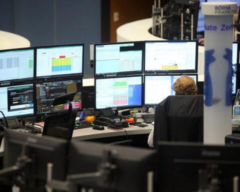 Frankfurter Börse mit Dax-Logo, steigenden Kurven und Handelsakteuren in Aktion.