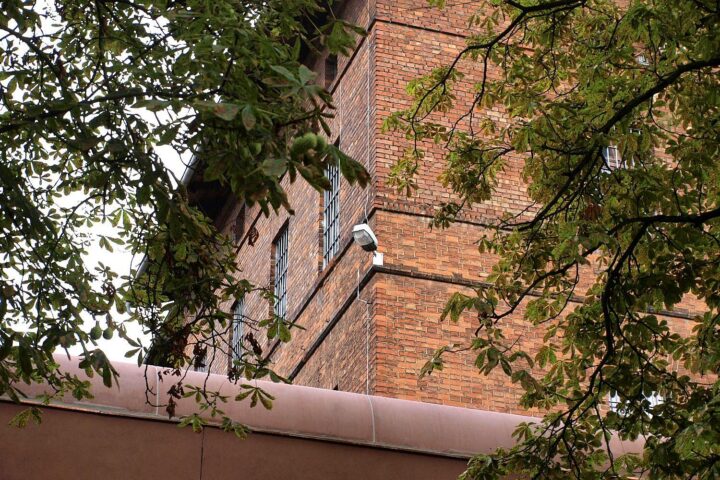 Ein Mann wird von Polizeibeamten im Gefängnisgewahrsam festgehalten.