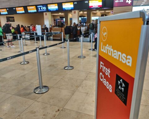 Lufthansa-Schalter während des Streiks, Passagiere und Protestierende unzufrieden dargestellt.