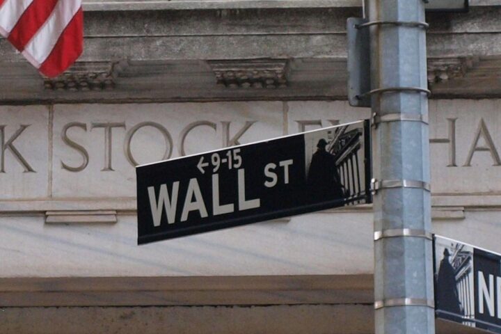Wall Street mit aufsteigenden Kursen und finanziellen Symbolen, repräsentiert durch Aktien und Indizes.