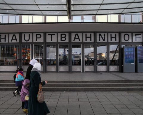 Frauen mit Kopftuch vor dem Ulmer Hbf, symbolisieren kulturelle Vielfalt und Urbanität in Deutschland.