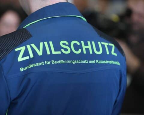 Zivilschutz-Mitarbeiter bei der Ausrüstung für Notfälle und Krisensituationen, mit Sicherheitsaspekten.