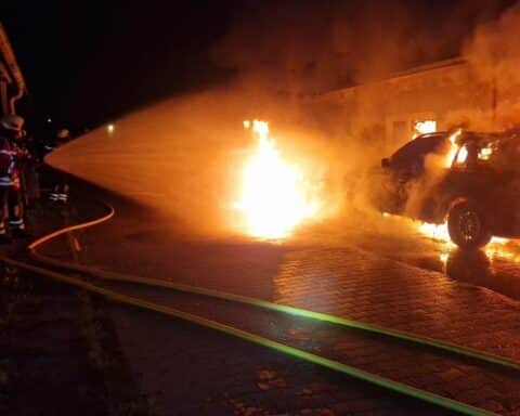 Flammen und Rauch aus Werkstattkomplex in Gundelfingen, Feuerwehr im Einsatz zur Brandbekämpfung.