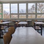 Ein moderner Klassenraum mit Schülern beim Religions- und Ethikunterricht, Bücher und digitale Geräte.