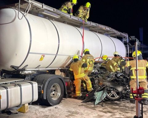 Schwerer Verkehrsunfall: beschädigter Audi und Sattelzug an Unfallort, Einsatzkräfte vor Ort.