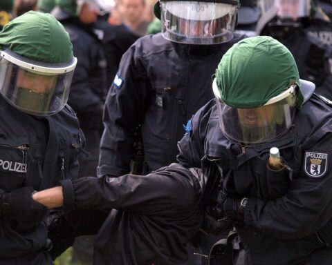 Polizisten bei einer Festnahme, Symbol für die Bekämpfung von Linksextremismus und Rechtsstaatlichkeit.