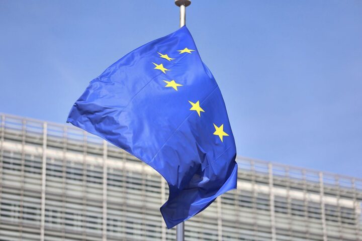 EU-Fahnen im Vordergrund, symbolisieren Partnerschaft und Fortschritt mit Afrika durch neues Abkommen.