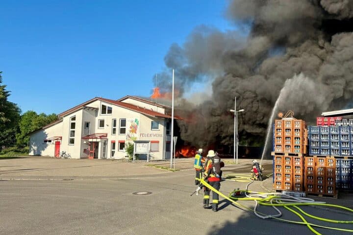 Großbrand im Feuerwehrhaus Unterensingen: Zerstörtes Gebäude, Rettungskräfte im Einsatz, flammende Rückstände.
