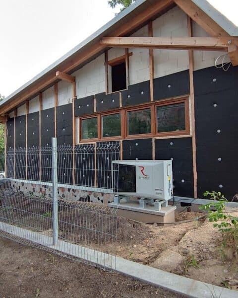 Neubau mit Wärmepumpe, symbolisiert Fördermittelverwendung und Energieeffizienz im Bauwesen.