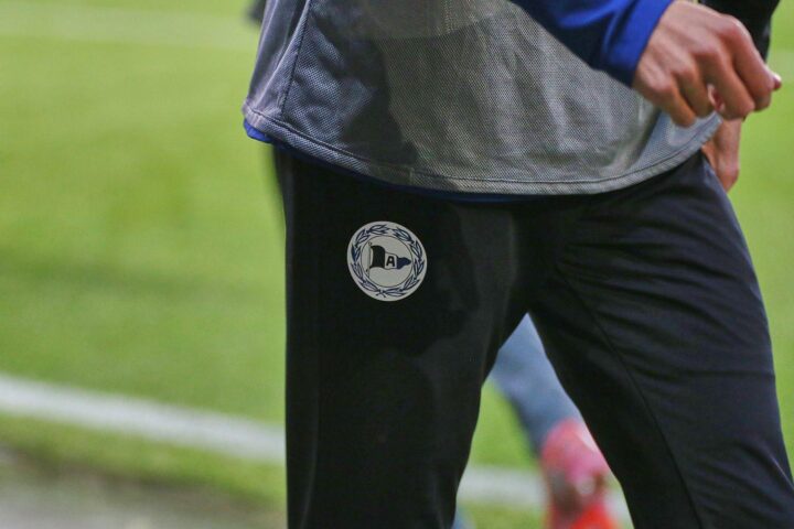 Arminia Bielefeld präsentiert Oliver Kirch als neuen Cheftrainer in jubelnder Teamumgebung.