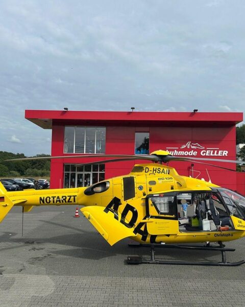 Rettungshubschrauber landet auf gesperrtem Parkplatz nach Unfall, Feuerwehr im Einsatz.