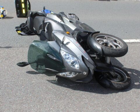 Ein verletzter Rollerfahrer neben seinem Dreirad, nach einem Unfall mit einem flüchtenden Geländewagen.
