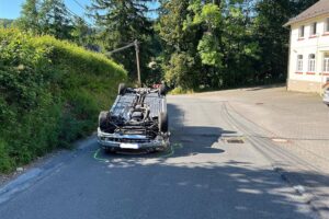 Ein Mercedes liegt nach Unfall auf dem Dach, nach Überschlag auf der Nochener Straße (L98).