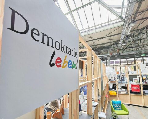 Messestand der Initiative "Demokratie leben" mit Informationen zur zivilgesellschaftlichen Förderung und Engagement.