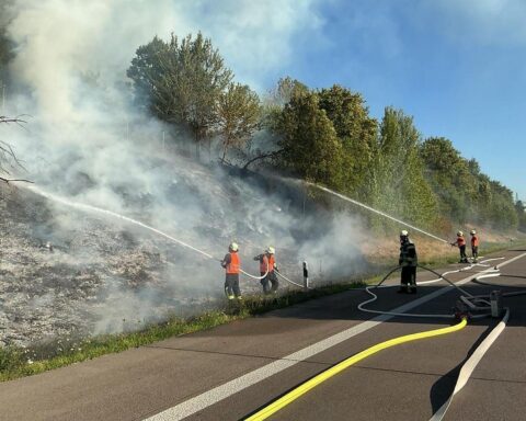 Feuerwehr bekämpft ausgedehnten Böschungs- und Vegetationsbrand an der A5 nahe Offenburg, mit gesperrten Fahrstreifen.