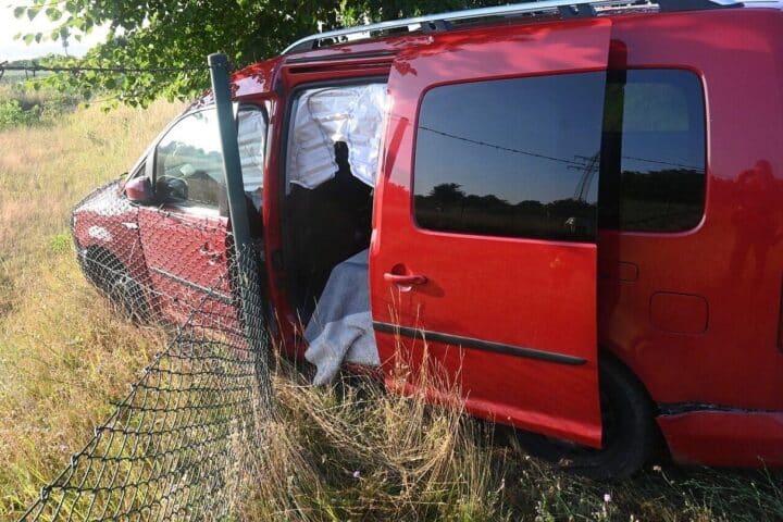 Unfallwagen auf der B188 bei Gardelegen, beschädigt nach Zusammenstoß mit Zaun; Feuerwehr und Polizei im Hintergrund.