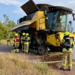 Feuerwehr bekämpft Brand eines Mähdreschers bei Erntearbeiten; starker Rauch am Fahrzeug (Archivfoto).