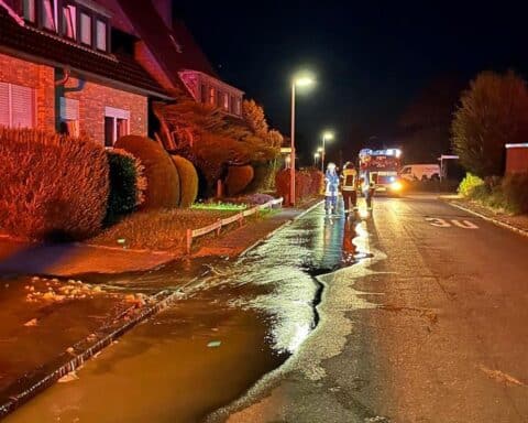 Wasserrohrbruch in Schermbeck, Feuerwehr im Einsatz, gesperrte Straße und fließendes Wasser.